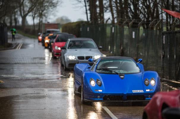 Staying 3 – 5 seconds behind the vehicle in front of you a line of super cars on wet road