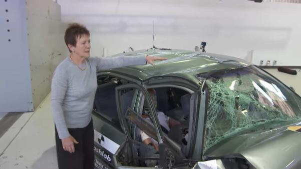 The 1998 Corolla model suffered “catastrophic structural failure” A woman standing next to a seriously damaged 1998 Corolla