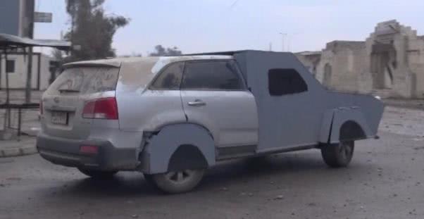 SUVs are the most capable over rough terrain and provide a more robust suspension system a silver Kia SUV with the front and rear wheels modified by IS terrorists