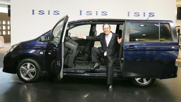 The Toyota’s Isis is designed with unique sliding doors a man in suit opening the sliding door of a Toyota Isis