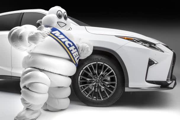 Michelin’s tire safety campaign is also dubbed as the Michelin Safe On The Road the Michelin Man standing next to a white car