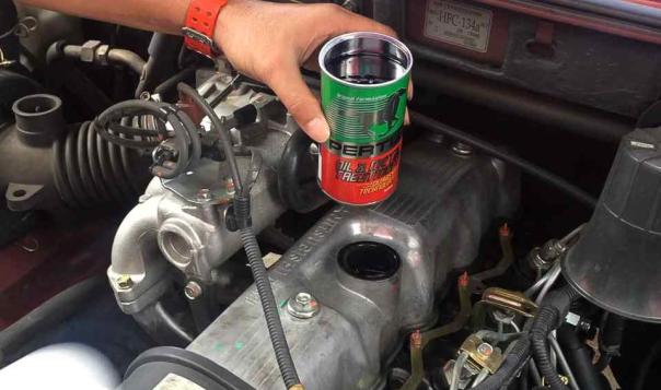 The most important thing to keep a car running better and longer is oil & metal treatment a can of Pertua Oil & Metal Treatment above engine hood