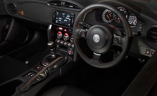 The cabin is adorned by a suede-like “Grandlux” material, embossed with an orange-colored 86 badging cabin of the 2017 Toyota 86 limited edition