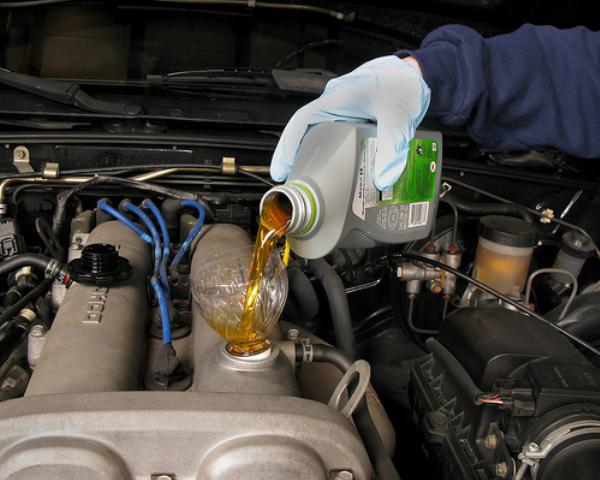 If the gearbox feels like a box of rocks during shifting, maybe it’s time for new transmission fluid fluid being poured into a car engine