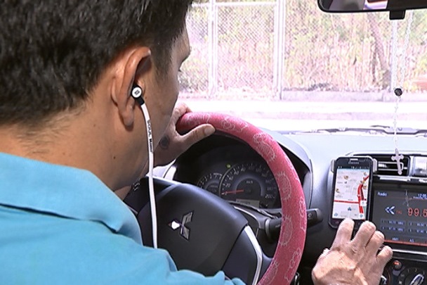 Under the Anti-Distracted Driving Act, drivers are allowed to mount GPS devices or smartphones on their dashboards A man using in a car a smartphone to check destinations