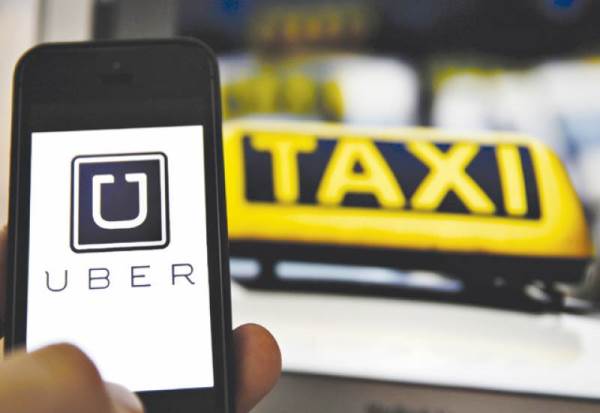 This Uber's impressive achievement took place in 24 countries including Philippines, Russia, Colombia, and India A man using the Uber app on his smartphone