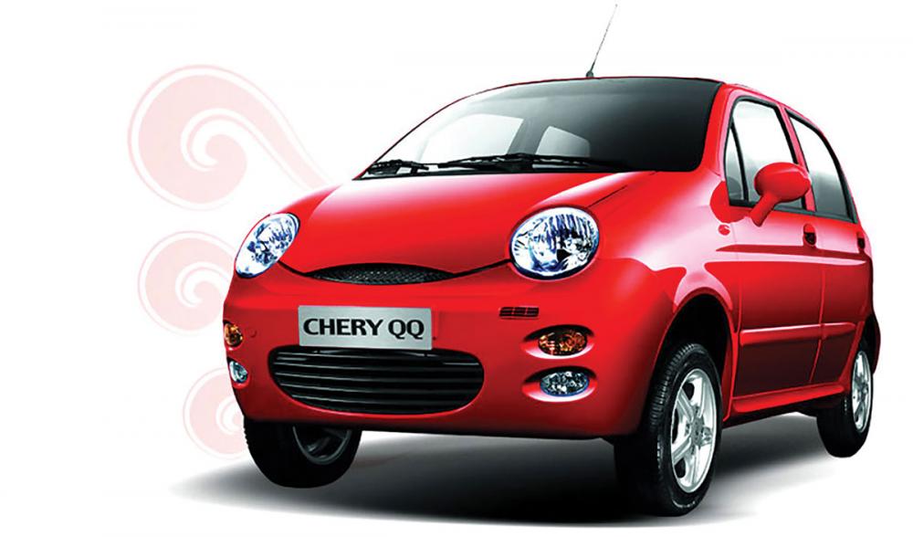 The driver of the Chery QQ is cute like the name of this car. angular front of a red Chery QQ