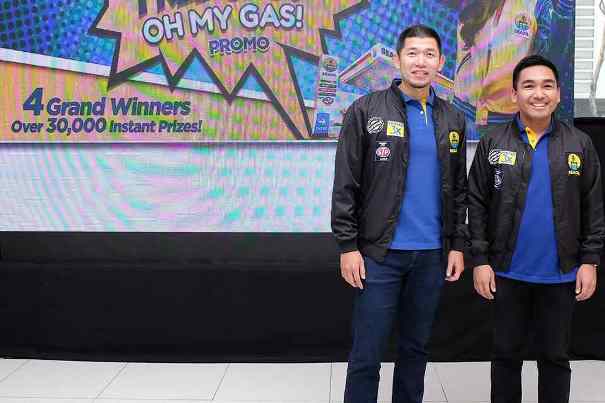 Seaoil to offer lifetime suppliers of fuel Two Seaoit staff standing in front of a LED screen