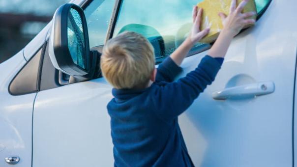 un bambino di pulizia di un auto