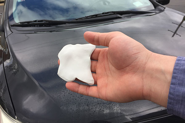 Man holding the clay bar