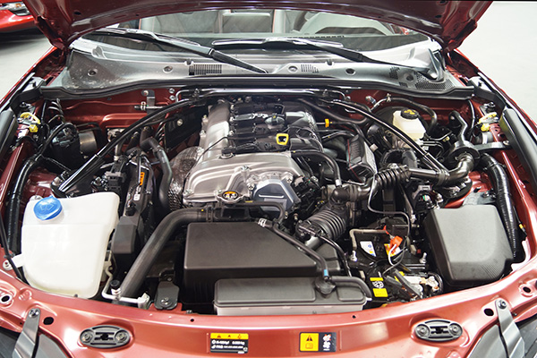 A picture of a MX-5 Miata's hood, displaying its SKYACTIV-G 2.0 liter engine