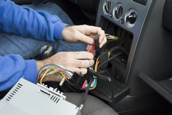 man checking car wirings