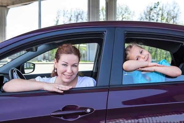 Mom and daughter inside a car