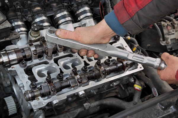 What does a car engine camshaft do?