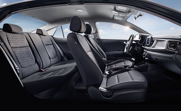 Comfortable and thankfully covered in a black material to combat those stains lighter colored fabrics tend to have with age. A picture of the Kia Rio's front and passenger cabin