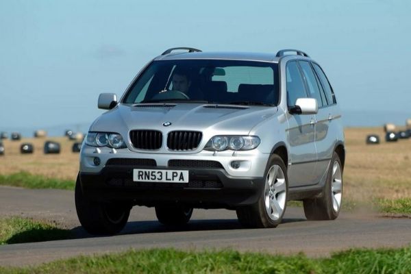 A picture of the first generation BMW X5 on the road