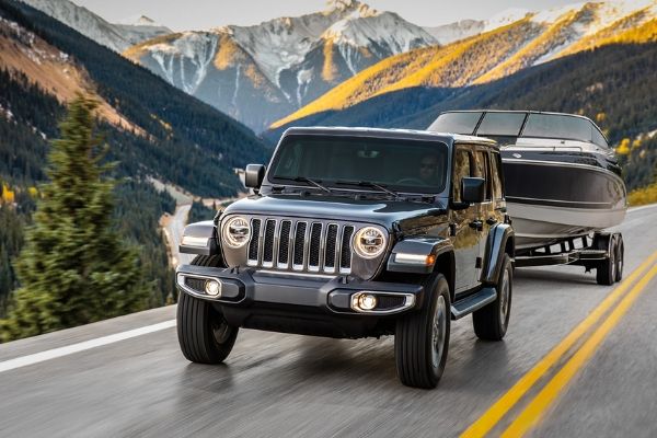 The 2020 Jeep Wrangler driving on a hill