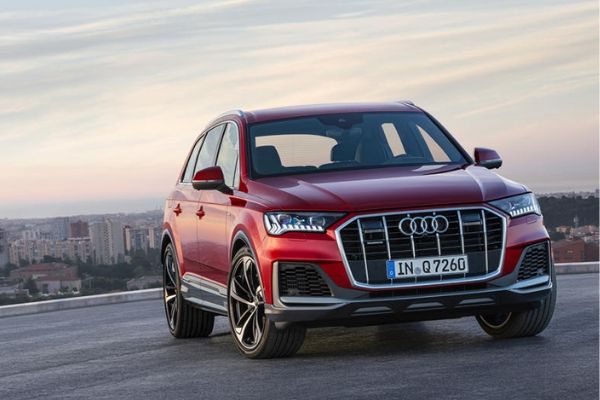 A red 2020 Audi Q7 with a skyline backdrop