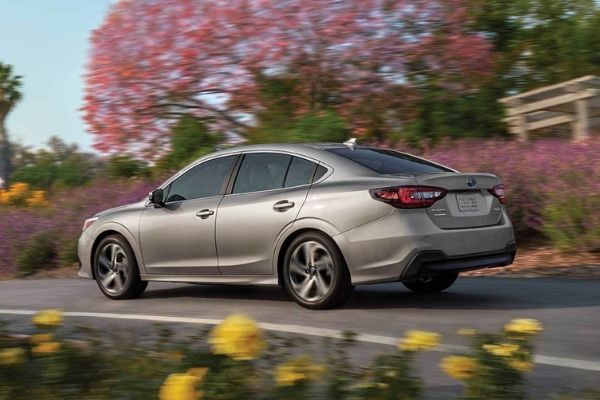 It ain't no slouch either A picture of the rear of the Subaru Legacy as it travels through a quiet road