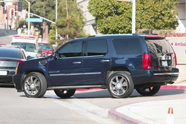 A cadillac escalade leaving the vicinity