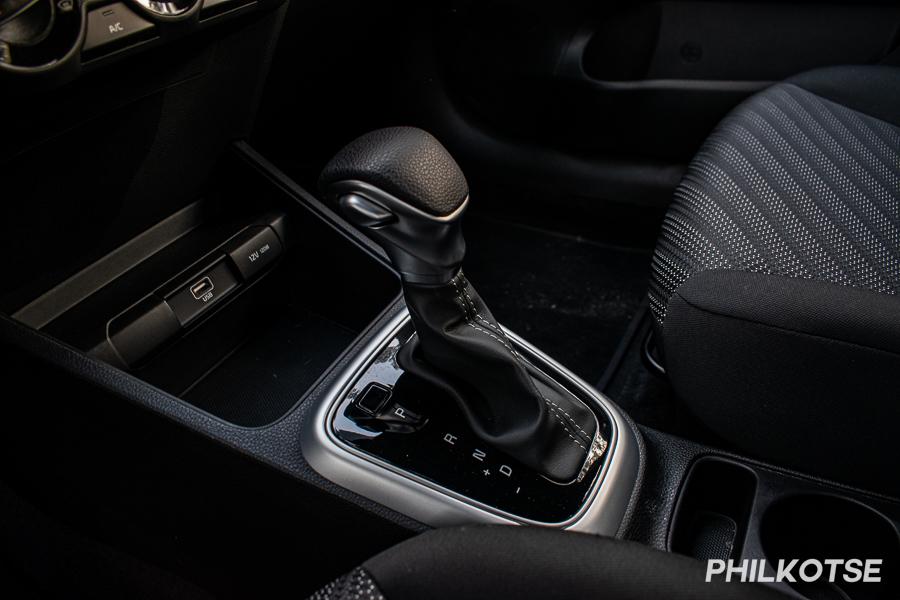 The shifter is surrounded by piano black plastic
