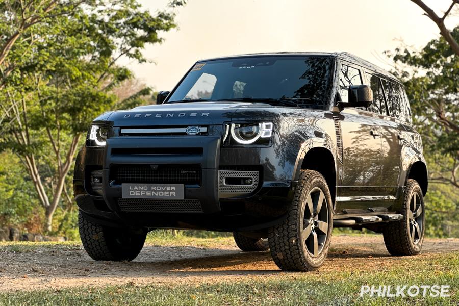 With its curb weight of 2,300 kilograms, this rig is a heavy weight A picture of the Defender 110 near a wooded area