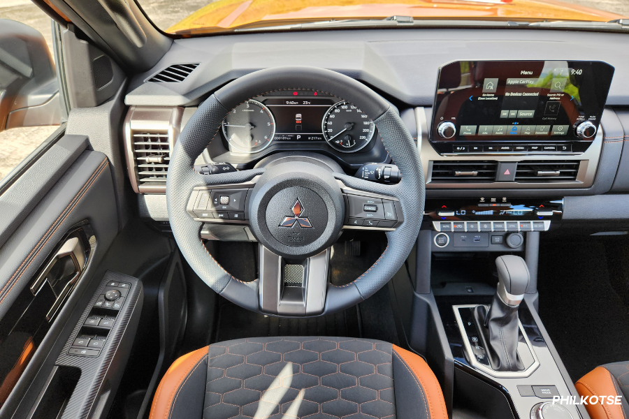 The Triton's steering wheel, digital driver's display, and analog gauge clusters.