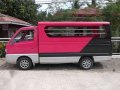 Passenger type suzuki multicab pink and blue and Nissan Urvan estate-3