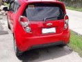 Red 2013 Chevrolet Spark at 65000 km for sale in Pampanga -1