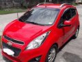 Red 2013 Chevrolet Spark at 65000 km for sale in Pampanga -0