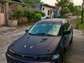 Black Mazda Protege for sale in Dau-4