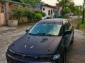 Black Mazda Protege for sale in Dau-0