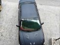 Black Mazda Protege for sale in Dau-1