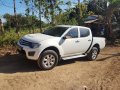  White Mitsubishi Strada 2012-3