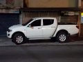  White Mitsubishi Strada 2012-1