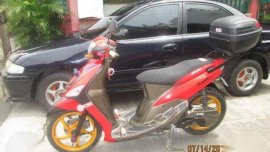 MAZDA 323 familia and YAMAHA Mio motorcycle