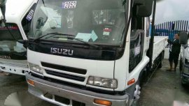 2016 Isuzu ELF Dropside 6HL 1 White MT Trucks 