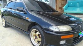 Mazda 323 1997 AT Black Sedan For Sale
