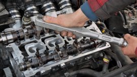 What does a car engine camshaft do?