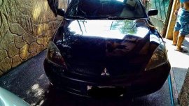 Black Mitsubishi Lancer 2010 for sale in Quezon City