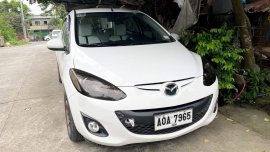 White Mazda 2 2014 model