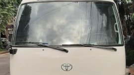 White Toyota Coaster 2008