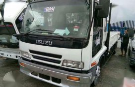 2016 Isuzu ELF Dropside 6HL 1 White MT Trucks 