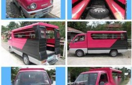 Passenger type suzuki multicab pink and blue and Nissan Urvan estate