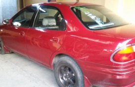 Red Mazda 323 1999 at 100000 km for sale