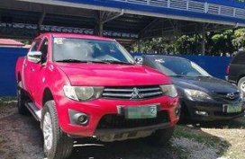 Red Mitsubishi Strada 2011 at 67000 km for sale 