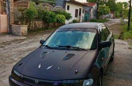 Black Mazda Protege for sale in Dau