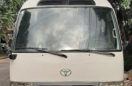 White Toyota Coaster 2008