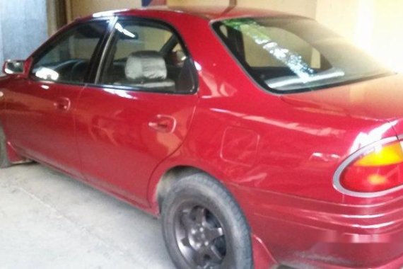 Selling Red Mazda 323 1999 Manual Gasoline in General Salipada K. Pendatun