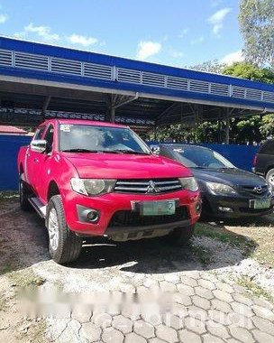 Red Mitsubishi Strada 2011 at 67000 km for sale 